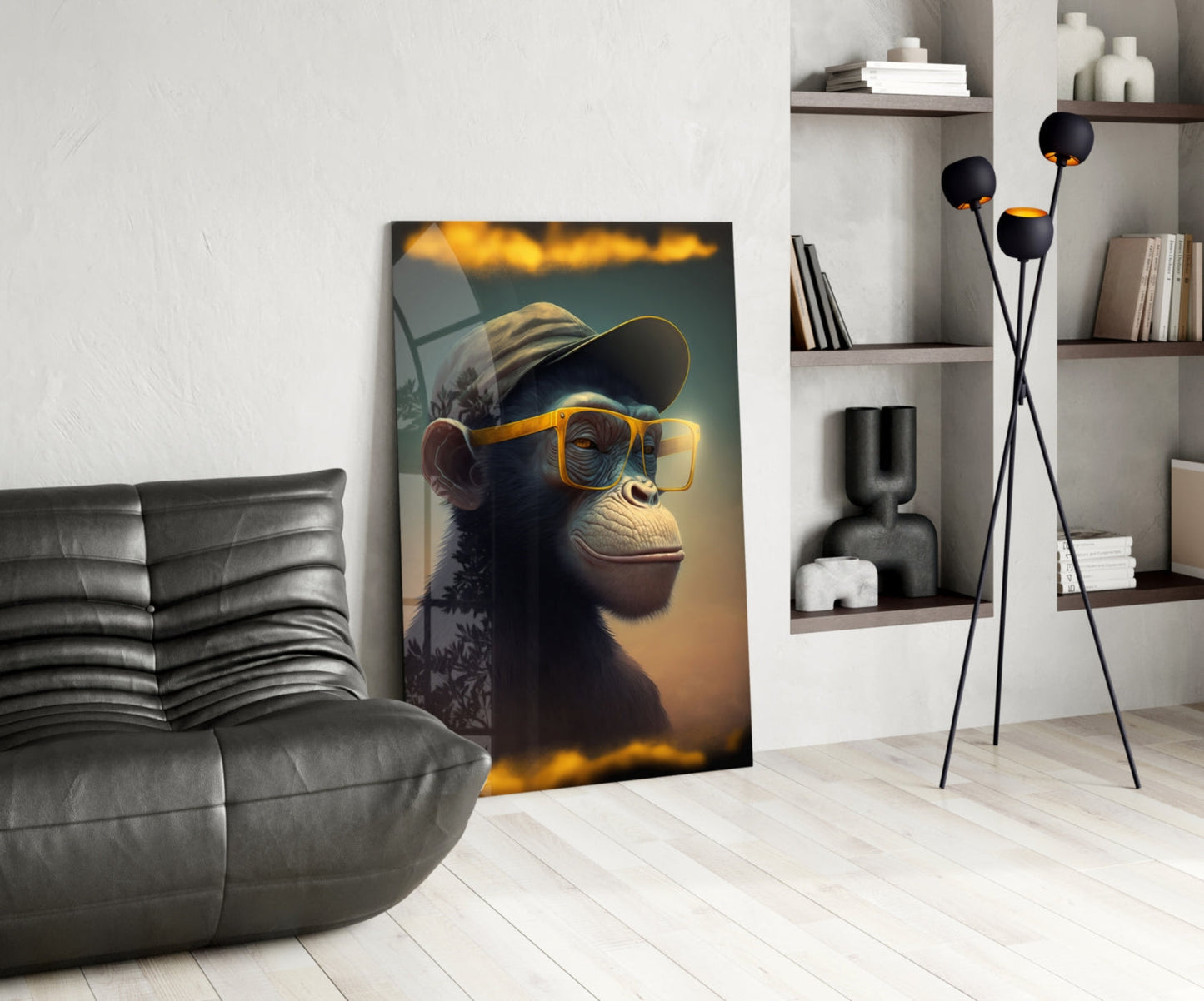 Modern living room interior featuring a glass wall art print of a chimpanzee wearing yellow sunglasses and a cap, displayed against white wall.