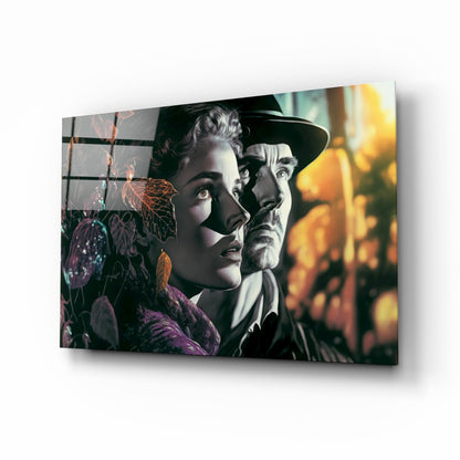 Glass wall art panel angled right showing two vintage-styled figures with purple flowers and warm golden background lighting.
