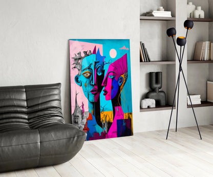 Vibrant multicolored glass art panel featuring abstract faces in pink, blue, and magenta tones displayed in modern living room setting.