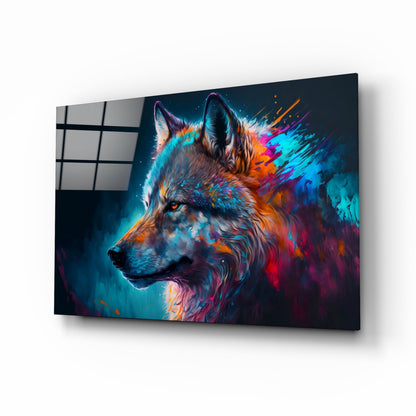 Angled view of glass wall art depicting a colorful wolf portrait with cyan, orange, and magenta paint splashes against dark background.