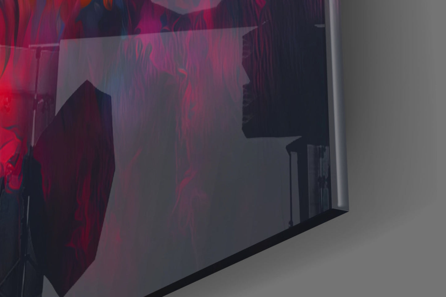 Angled view of glass wall art with red and dark silhouettes of wolves against translucent panel, mounted on white wall.