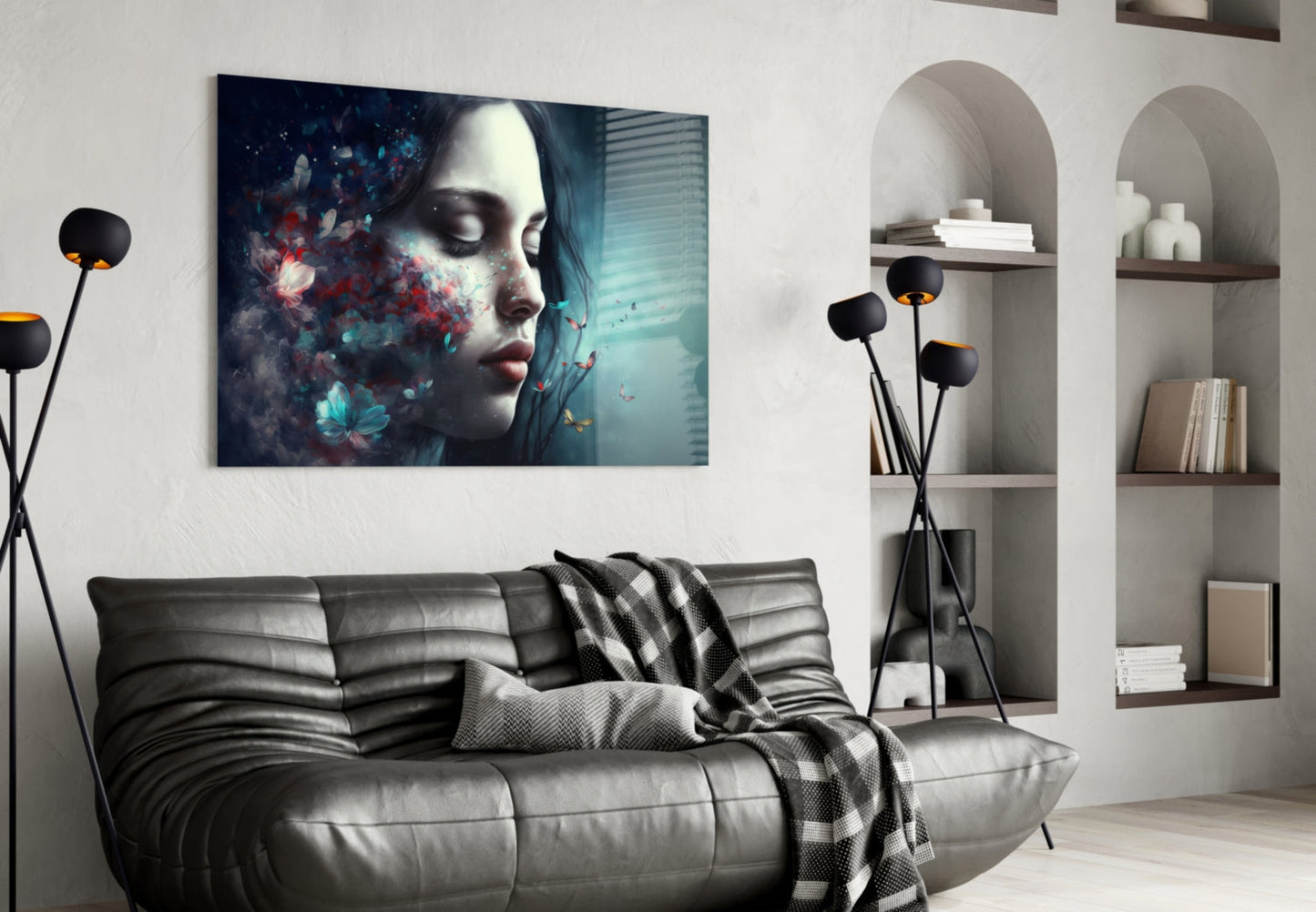 Glass wall art featuring a woman's profile with colorful flowers and particles in teal and red tones, displayed above a gray sofa.