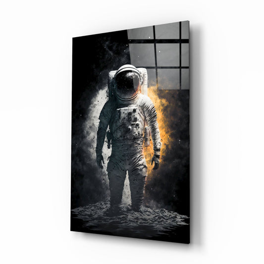 Angled product display of glass wall art featuring a white-suited astronaut standing on lunar surface with dramatic white and gold atmospheric effects against black background.