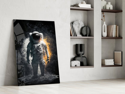 Black glass panel leaning against white wall displays dramatic astronaut in spacesuit with golden and white lighting effects against dark background.