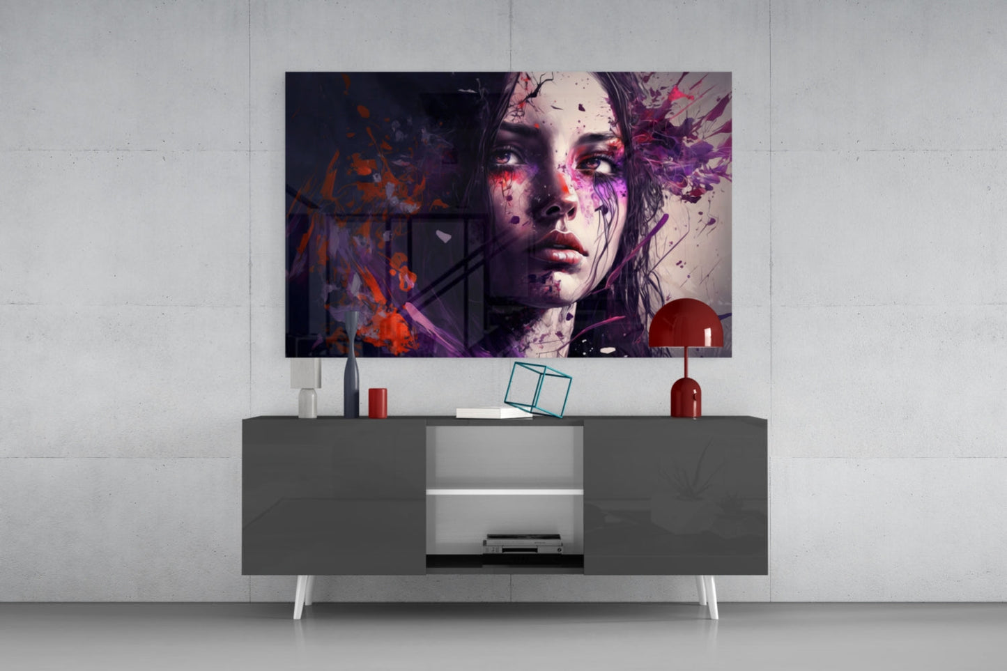 Modern living room setup showing abstract portrait glass wall art with purple, pink, and orange splatter effects displayed above a dark gray media console with white legs.