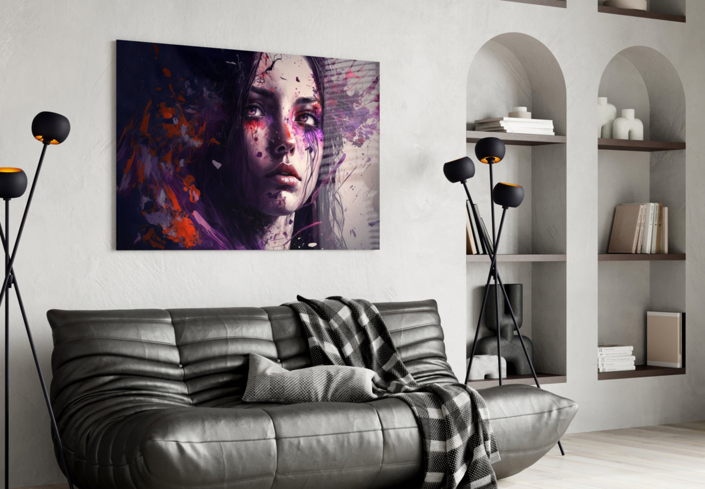 Modern living room with dark leather sofa displaying colorful portrait glass art above it featuring purple and orange tones on woman's face.
