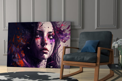 Glass wall art featuring a woman's face with purple, red, and orange watercolor splatter effects displayed in a modern living room with a wooden chair.
