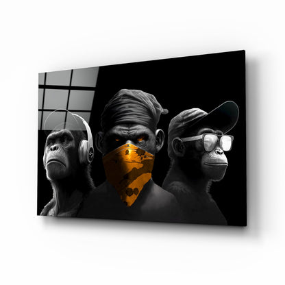Three stylized chimpanzees in black and white with orange accents, wearing headphones, mask, and sunglasses, displayed on glass against dark background.