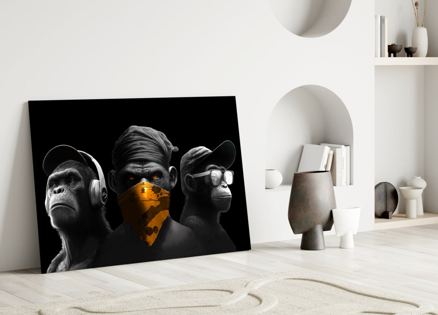 Black and white glass art featuring three monkeys with headphones, sunglasses, and gold bandana, displayed on floor against white interior wall.