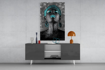 Black and white portrait of a woman with turquoise headwrap, sunglasses, and earrings displayed above a gray console table.