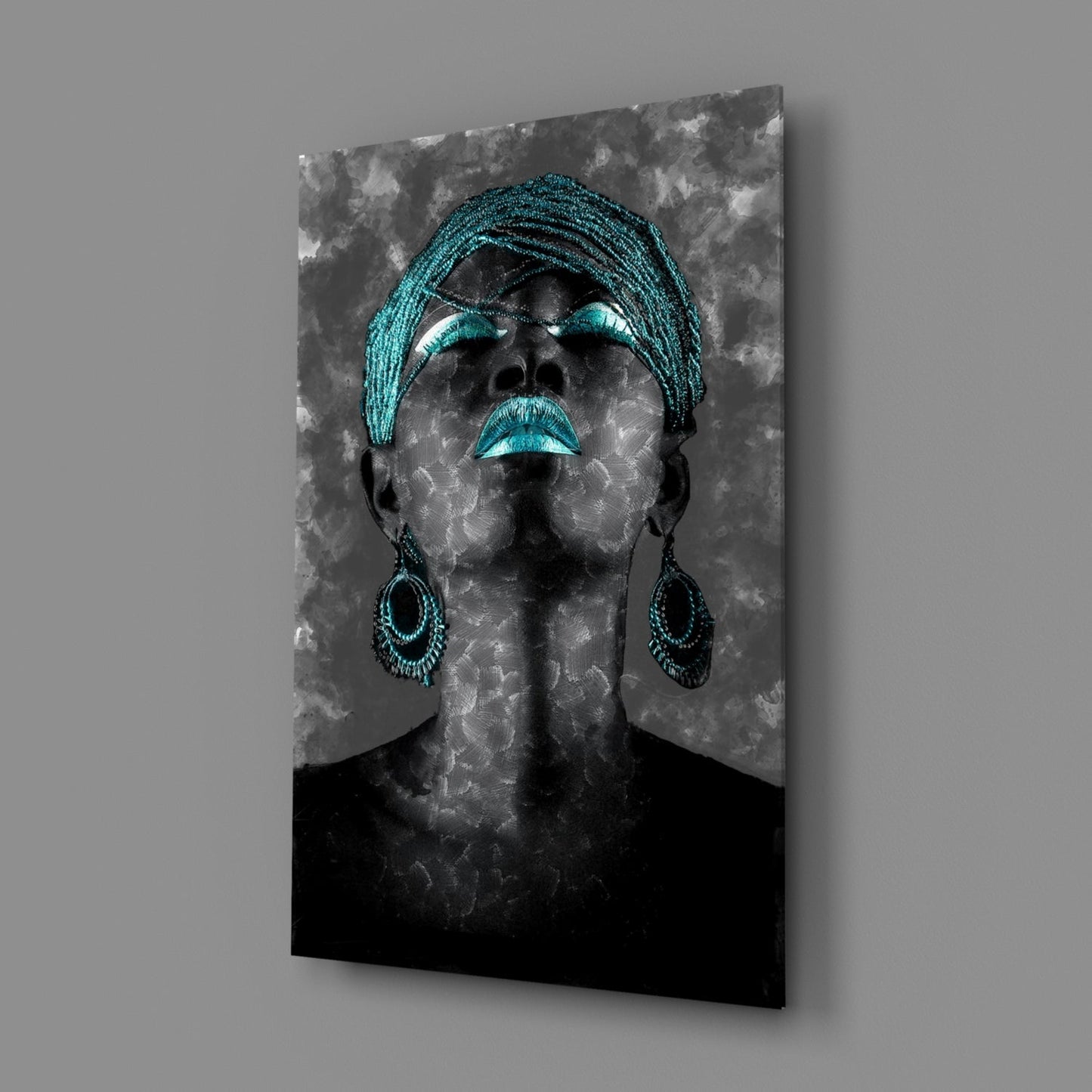 Portrait of woman wearing turquoise head wrap and dangling earrings on textured gray glass panel.