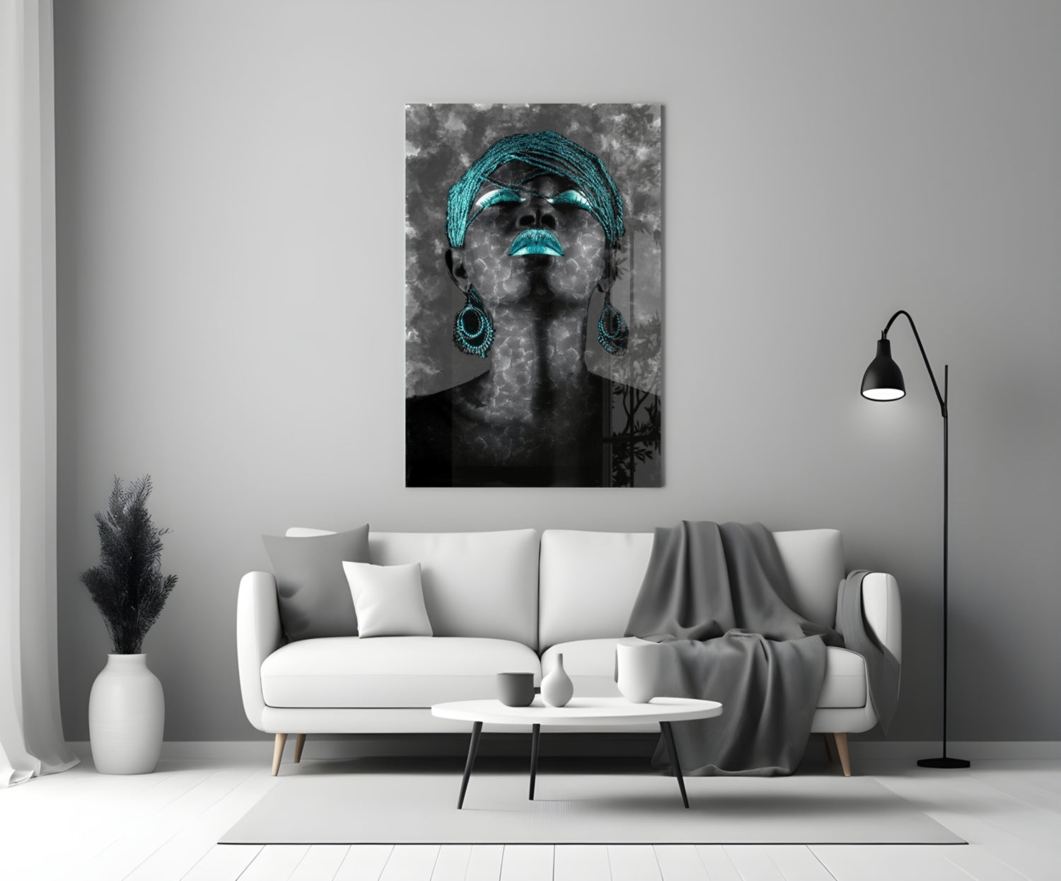 Black and white portrait with turquoise glowing eyes, lips, headwrap and earrings displayed above white sofa in modern living room.