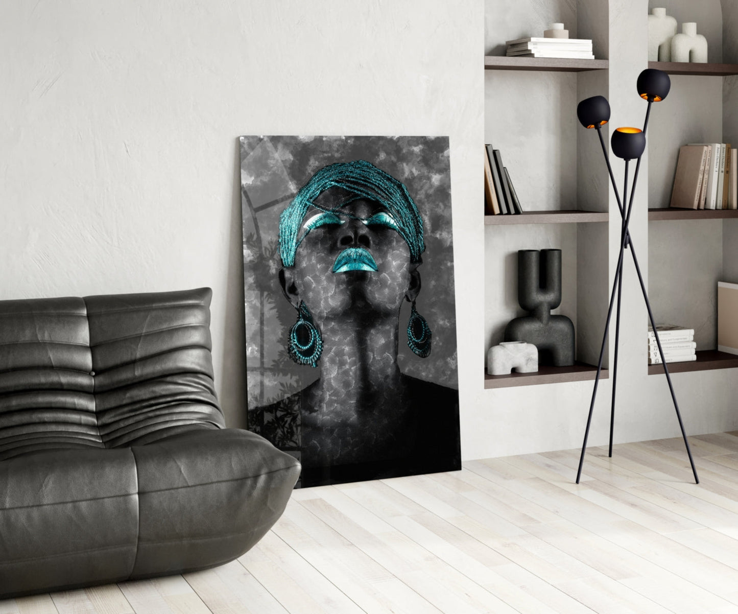 Modern living room featuring a black and turquoise portrait glass wall art displayed beside a gray leather chair and wall shelving.