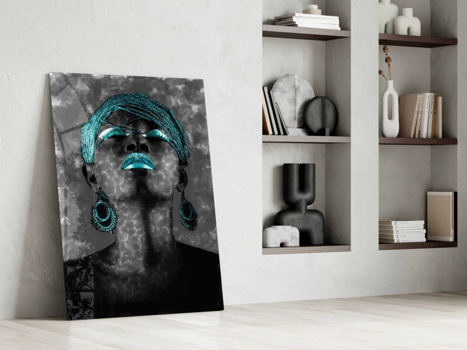 Modern interior displaying turquoise and black portrait glass wall art leaning against white wall beside built-in shelving with decorative objects.