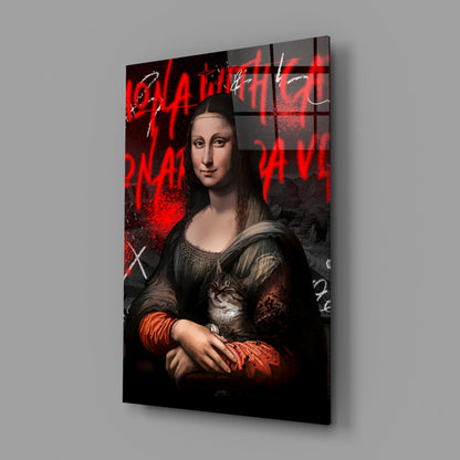 Angled view of glass wall art featuring Mona Lisa holding a cat, with red neon-style text and graffiti markings on dark background.