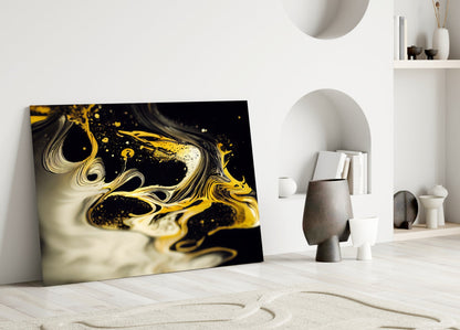 Golden Splash Glass Wall Art leaning against white wall in minimalist room with sculptural white and grey decorative objects and shelving.