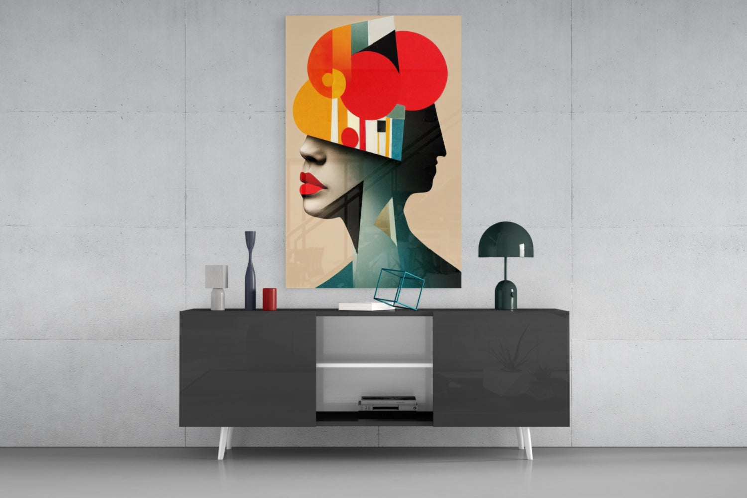 Geometric Thoughts glass wall art displayed above a dark console table, featuring an abstract portrait with red, orange, and teal geometric shapes.