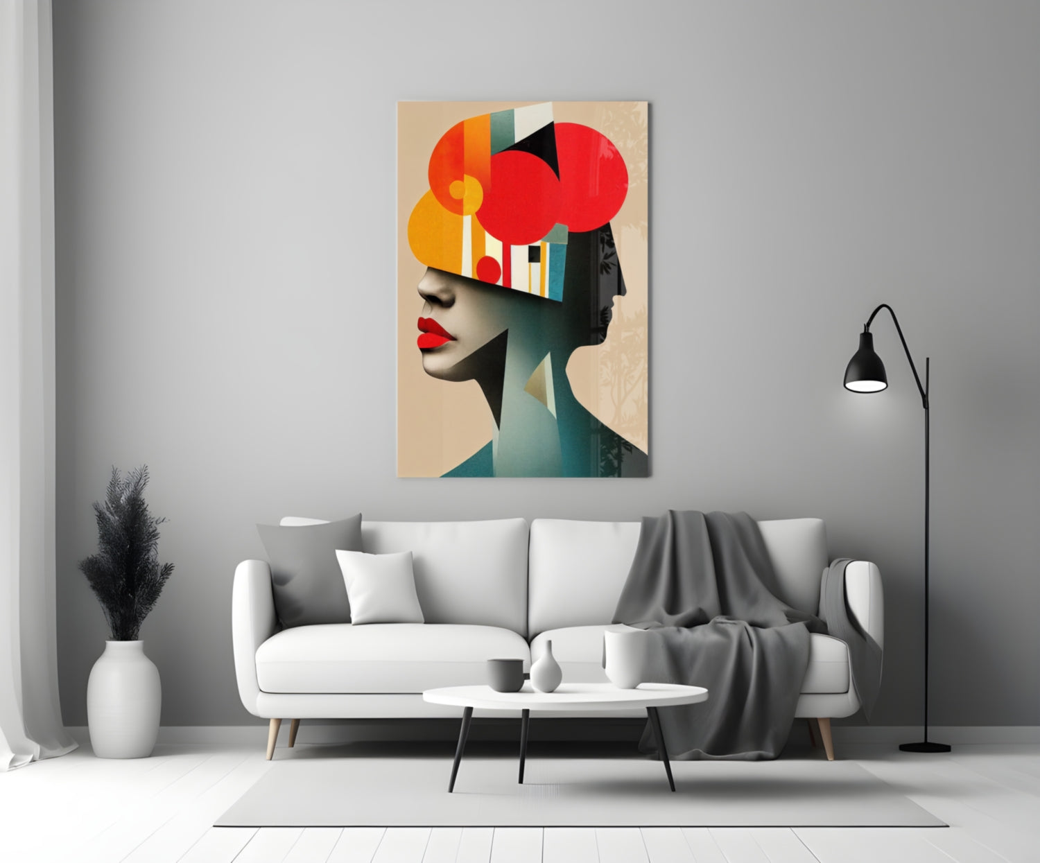 Modern living room with geometric abstract portrait artwork featuring red circles and colorful striped elements displayed above white sofa.