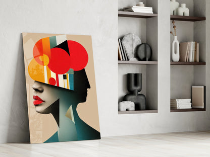 Modern abstract portrait canvas leaning against white wall beside built-in shelving with decorative objects and books.