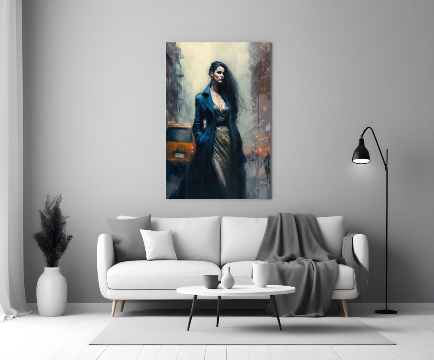 Glass wall art depicting a woman in dark blue coat standing in an urban setting, displayed above a white sofa in a modern living room.