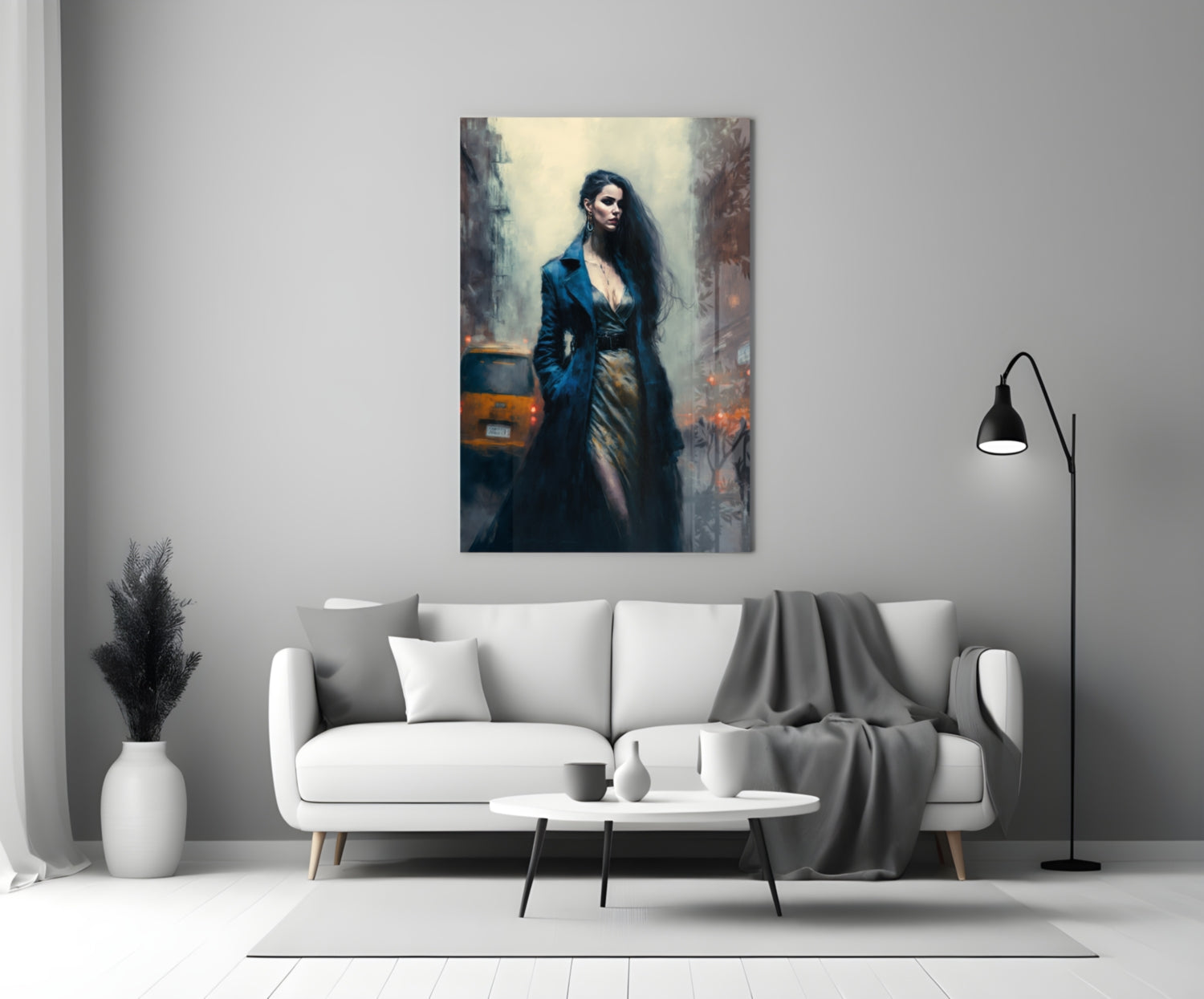Glass wall art depicting a woman in dark blue coat standing in an urban setting, displayed above a white sofa in a modern living room.