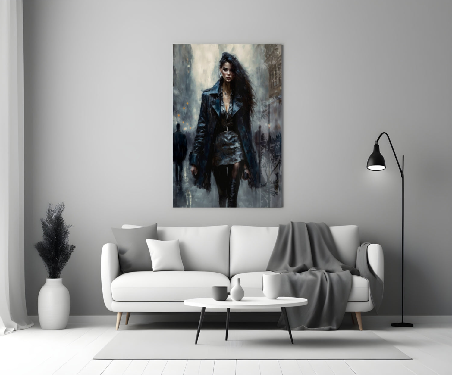 Glass wall art depicting a woman in dark leather jacket and long black hair standing in an urban setting, displayed above a white sofa in a modern living room.