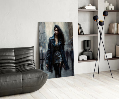 Modern living room interior featuring glass wall art of a dark-haired woman in black coat displayed leaning against white wall near gray sofa.