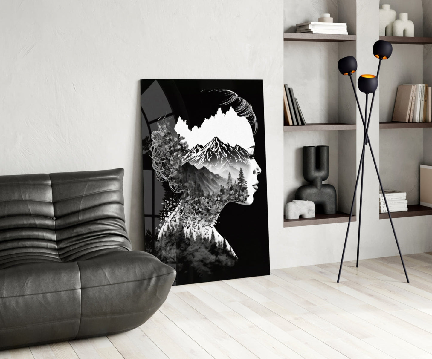 Black and white double exposure glass art featuring a woman's profile merged with mountain and forest imagery, displayed in a modern living room setting.