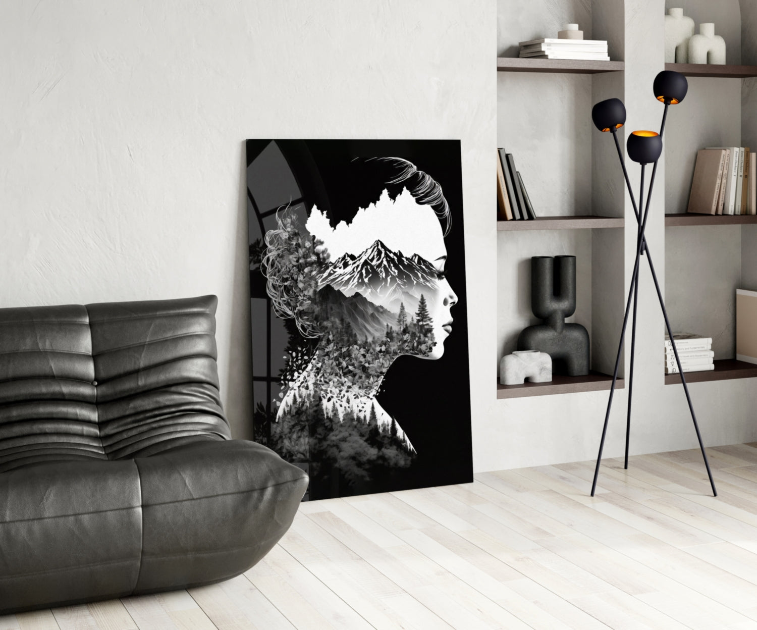 Black and white double exposure glass art featuring a woman's profile merged with mountain and forest imagery, displayed in a modern living room setting.