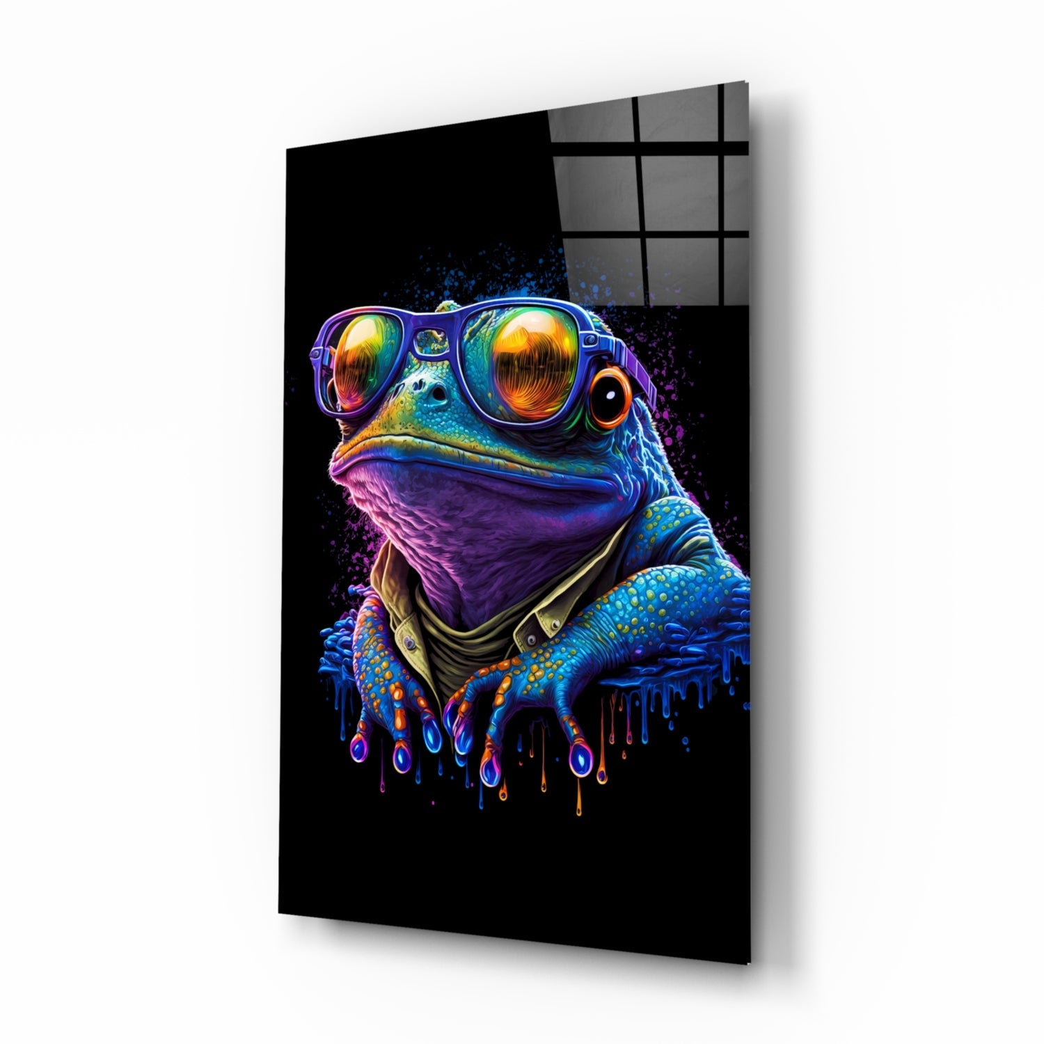 Angled view of a glass wall art panel displaying a neon-colored frog wearing sunglasses and a purple bandana against a black background.