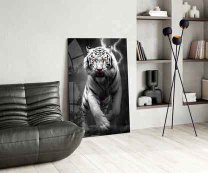 Black and white tiger with glowing eyes and lightning backdrop displayed as glass art in modern living room with leather chair and shelving.