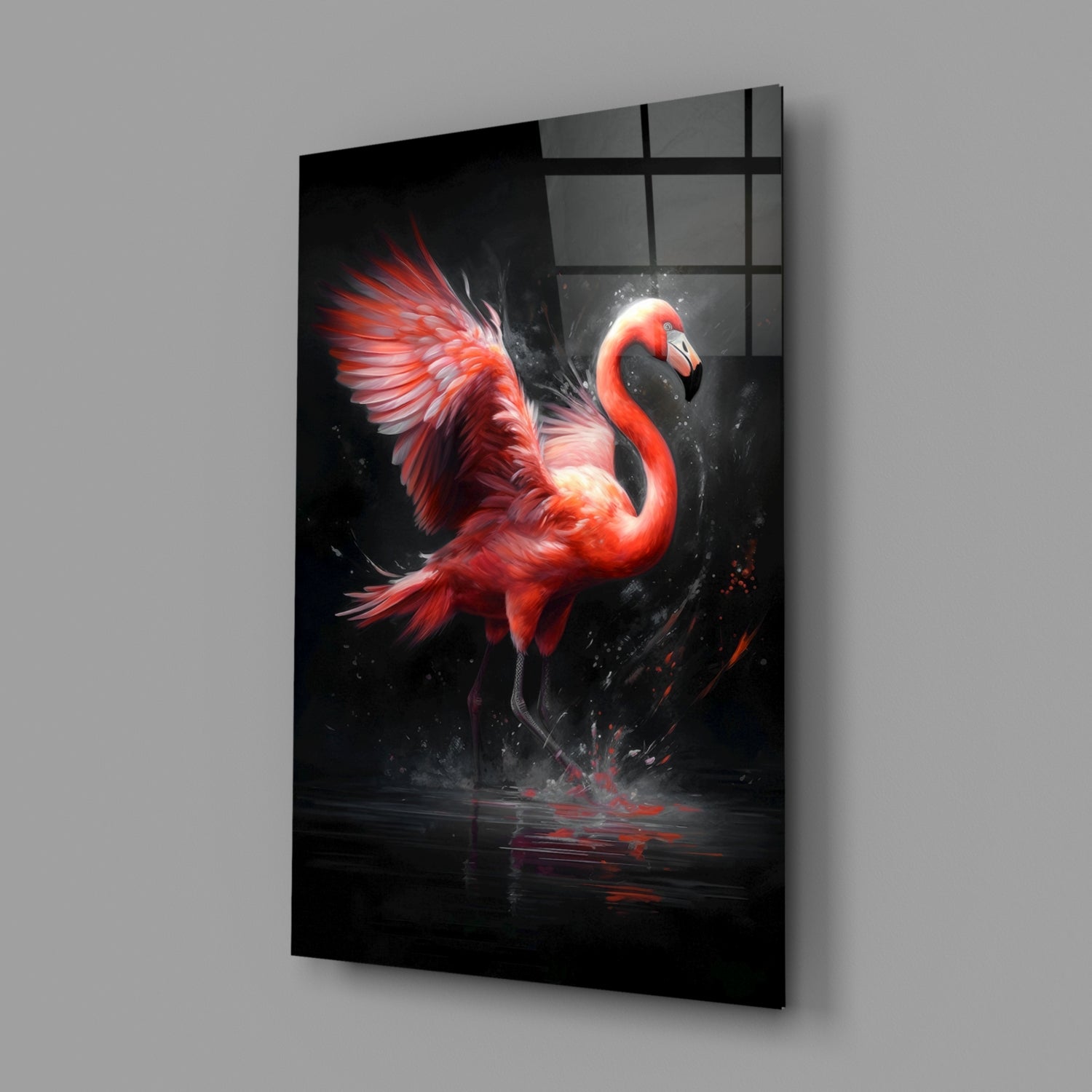 A vibrant red flamingo with dynamic splashing effects depicted on black glass wall art, displayed at an angled perspective against a gray background.