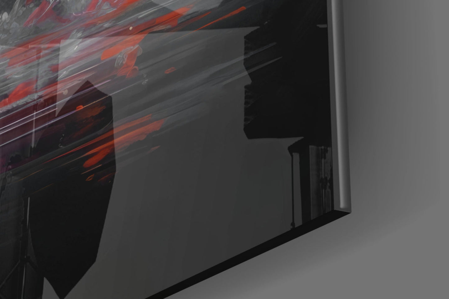 Close-up angled view of glass wall art showing red and orange streaked design against dark background on white wall.