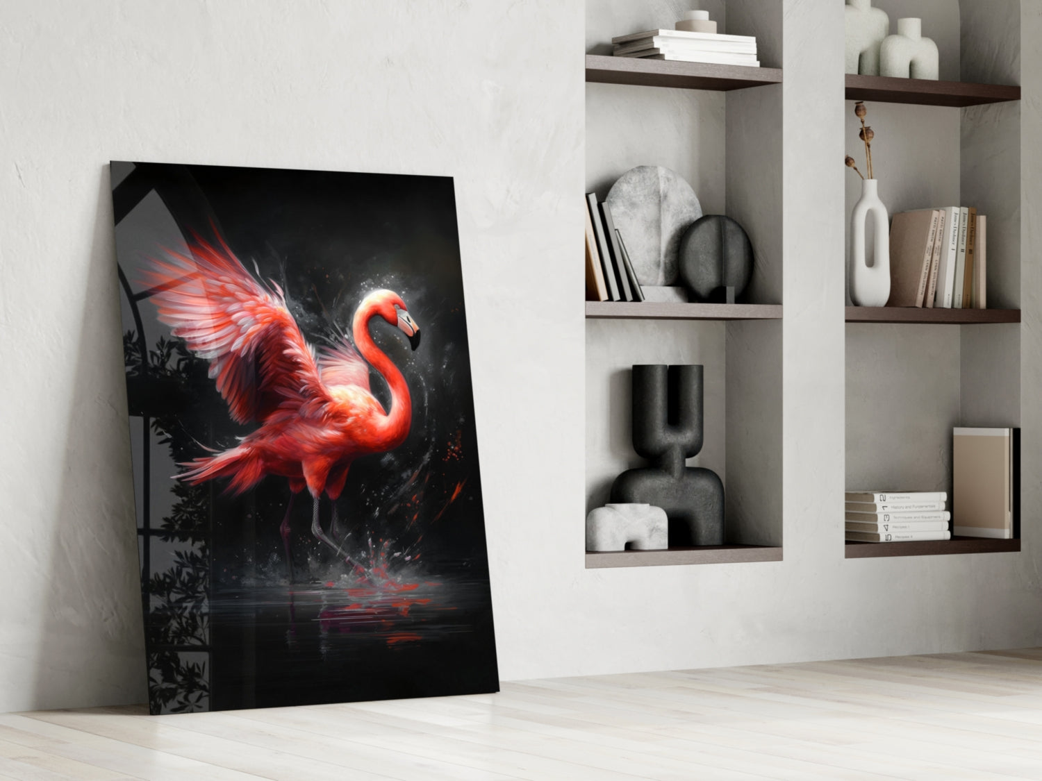 Red and black flamingo glass wall art leaning against white wall beside built-in shelving with books and decor.