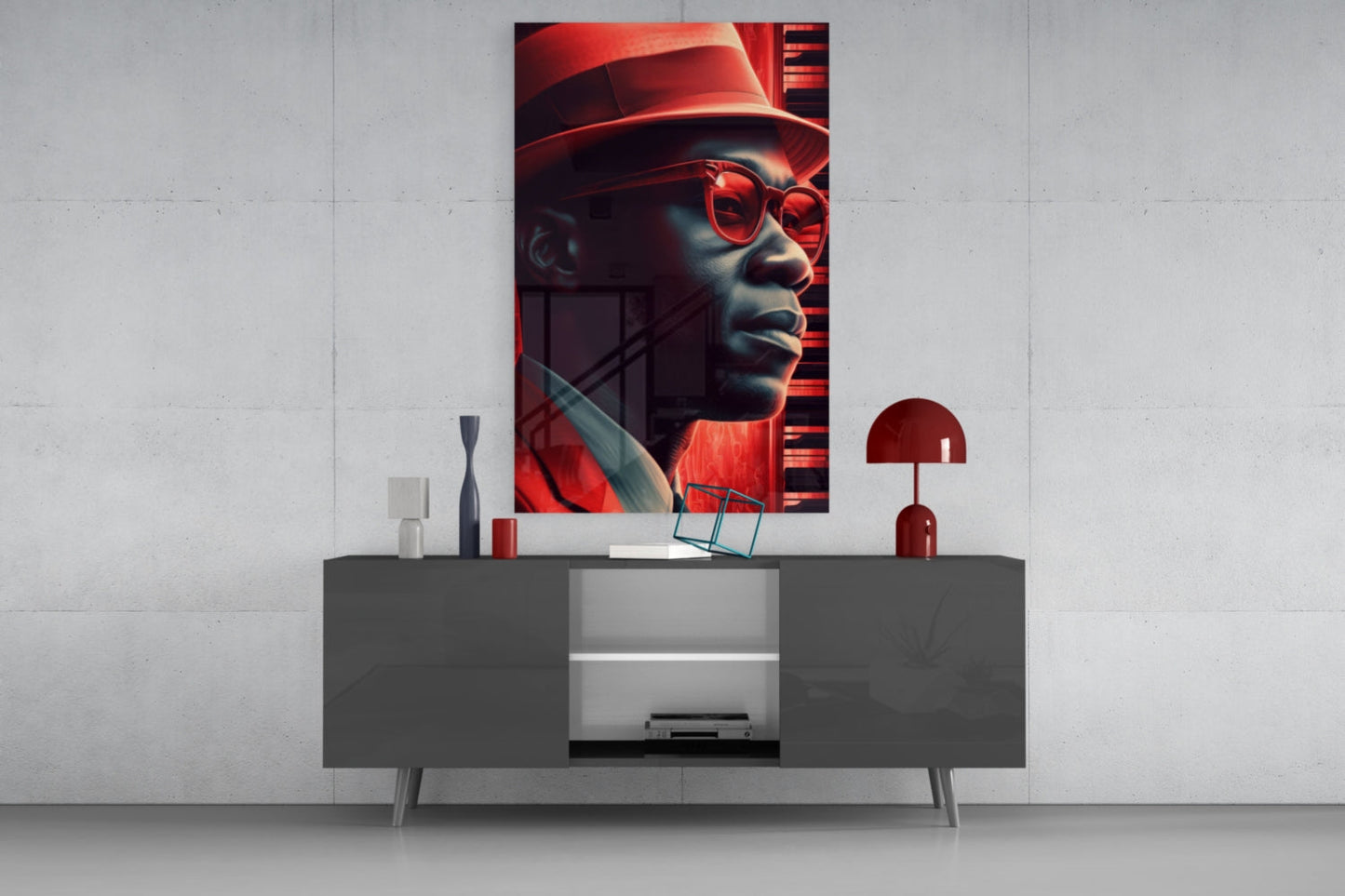 Vertical glass wall art featuring a stylized portrait of a man wearing red sunglasses and hat, displayed above a modern gray console table with decorative accessories.