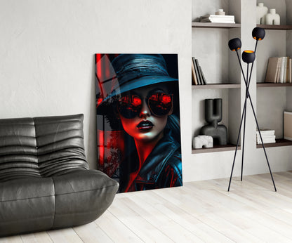 Modern living room interior displaying glass wall art featuring a woman in blue hat and red-glowing sunglasses against dark background.