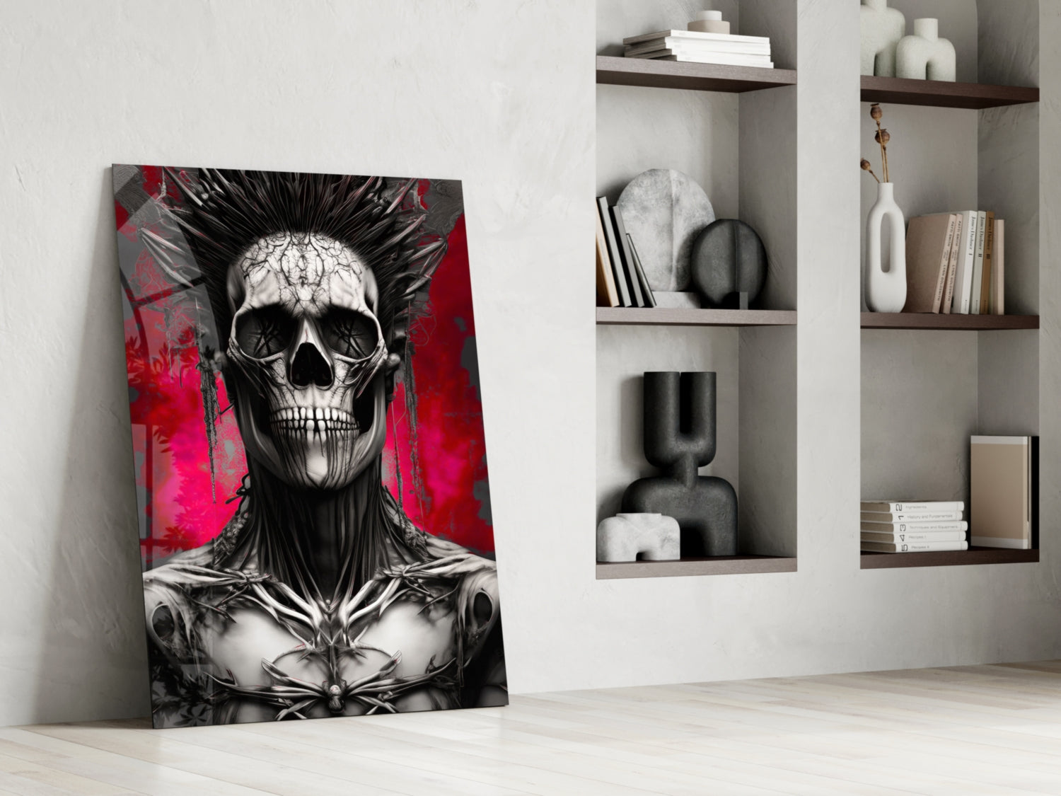 Leaning glass wall art featuring black and white skull with spiky hair against vibrant red and magenta background, displayed in modern white room with wooden shelves.