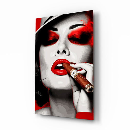 Angled view of glass wall art depicting a woman with pale complexion, red eyeshadow, red lips, and black hair, smoking a brown cigar, against red and white background.