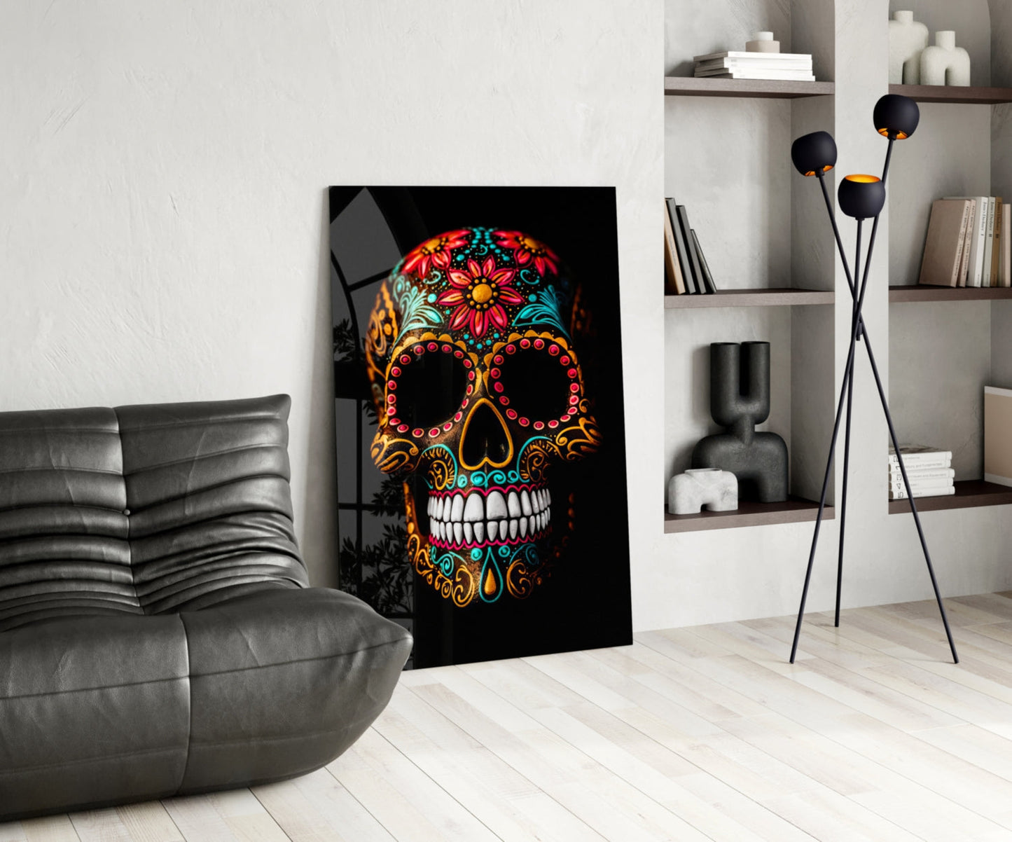 Vibrant skull glass wall art with colorful floral patterns displayed in modern living room setting beside gray leather chair.