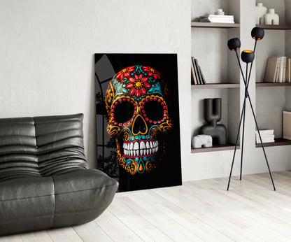 Vibrant skull glass wall art with colorful floral patterns displayed in modern living room setting beside gray leather chair.