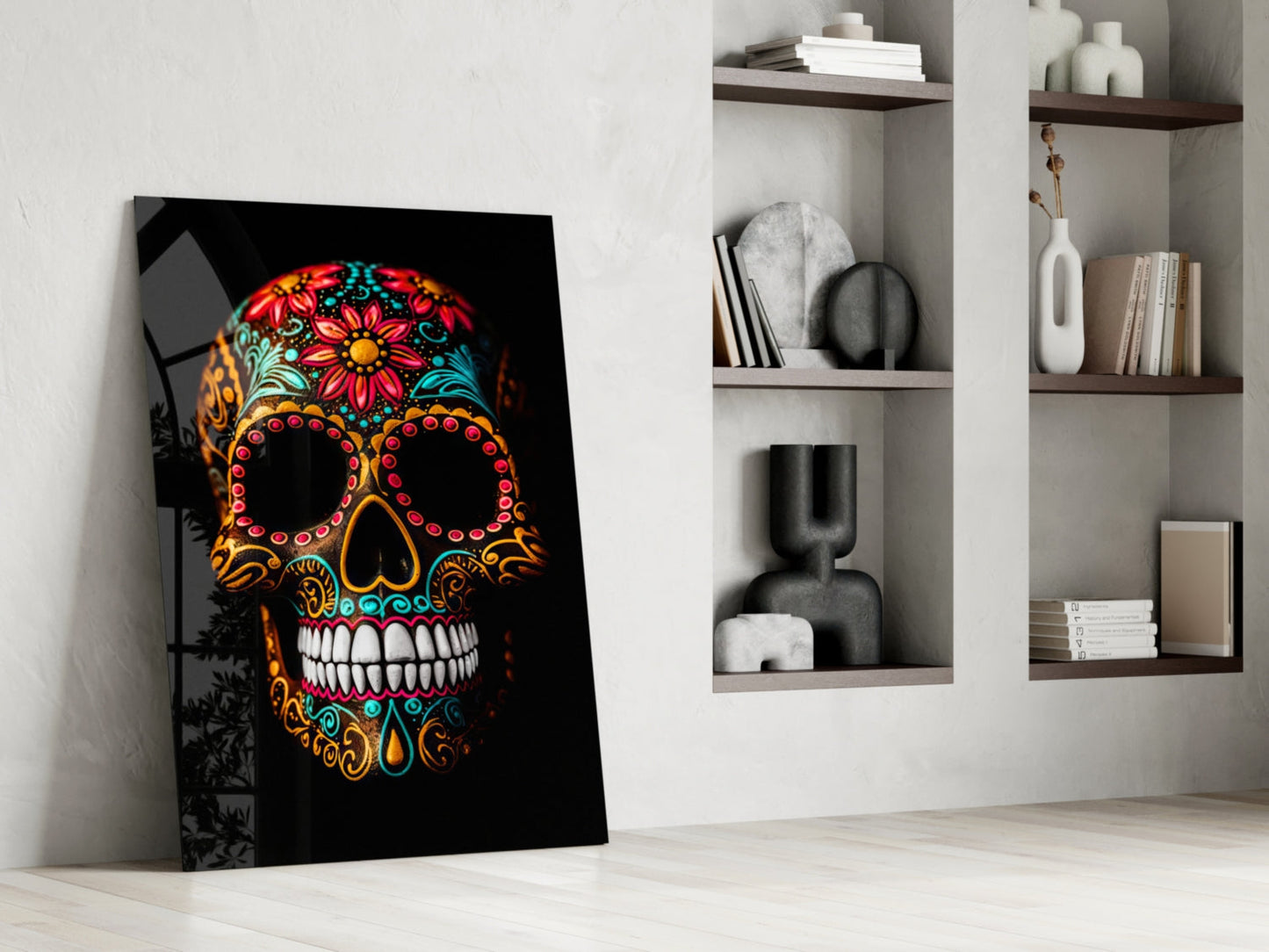 Colorful Day of the Dead skull with vibrant floral patterns and ornate designs on black background, leaning against white wall next to shelving unit.