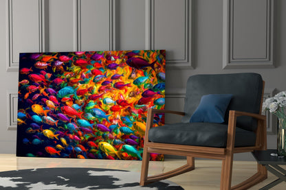 Vibrant glass wall art displaying colorful tropical fish in reds, blues, yellows, and purples, displayed in modern living room setting.