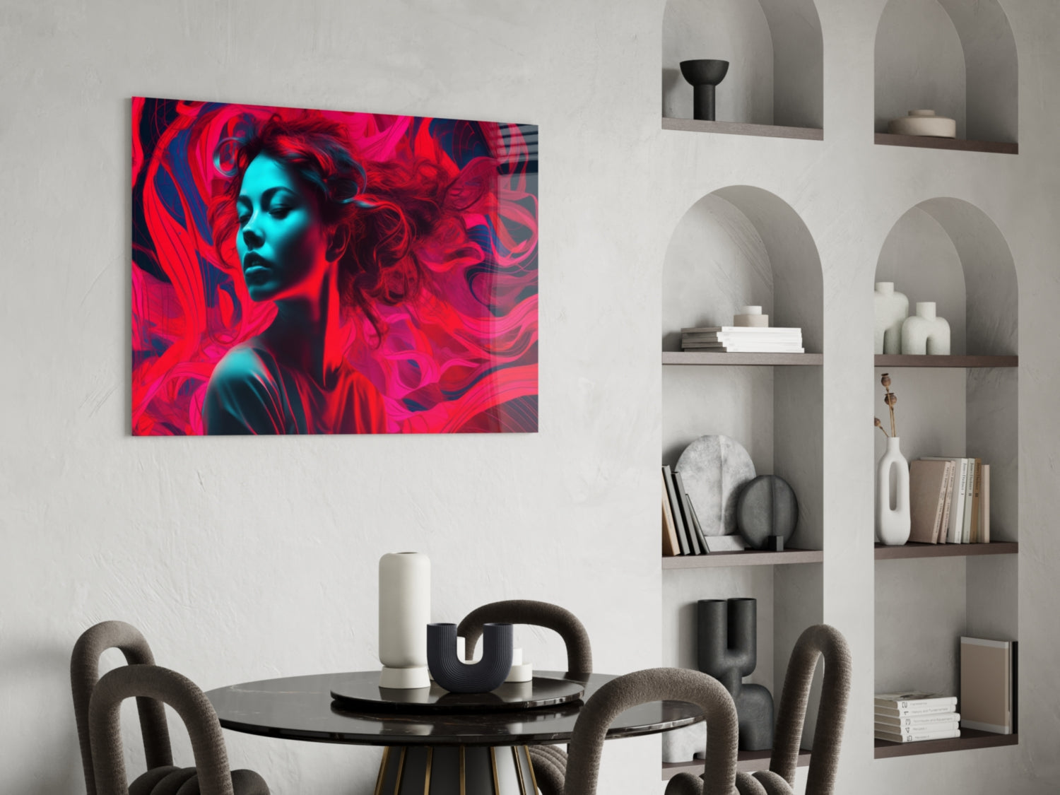 Vibrant red and cyan glass art featuring a stylized female portrait displayed above a round dining table in a modern interior.