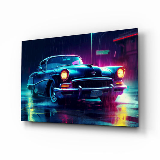 Angled perspective view of a neon-lit vintage 1950s car with glowing headlights on a wet surface, displayed as a glass wall art panel with cyan, magenta, and yellow lighting effects.