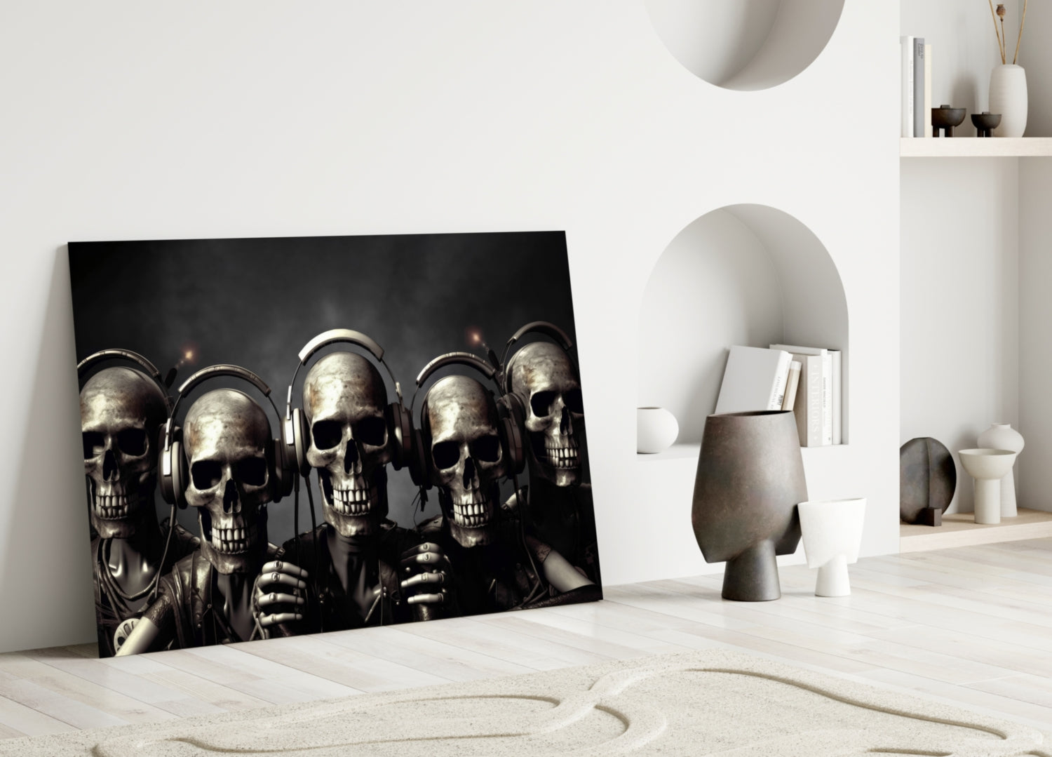 Skull Party glass wall art leaning against white wall in minimalist room setting with decorative objects and shelving.