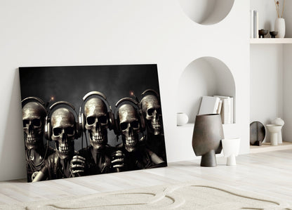 Skull Party glass wall art leaning against white wall in minimalist room setting with decorative objects and shelving.