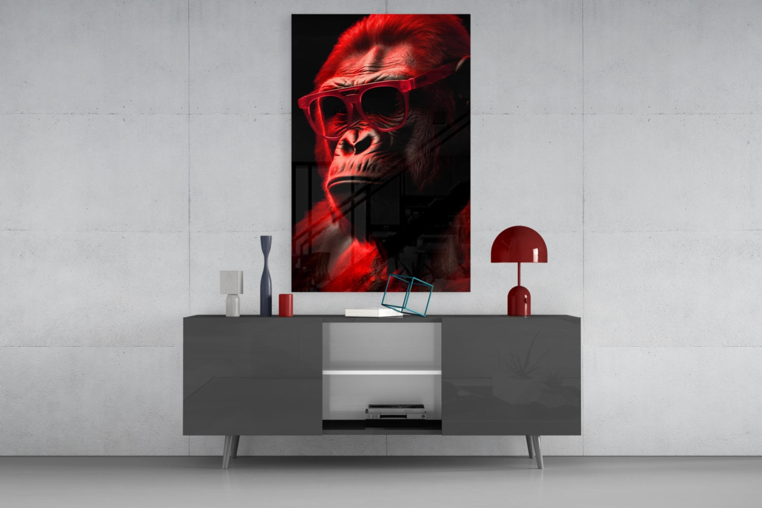 Red-lit gorilla wearing sunglasses displayed as wall art above gray media console with red lamp and decorative accessories.