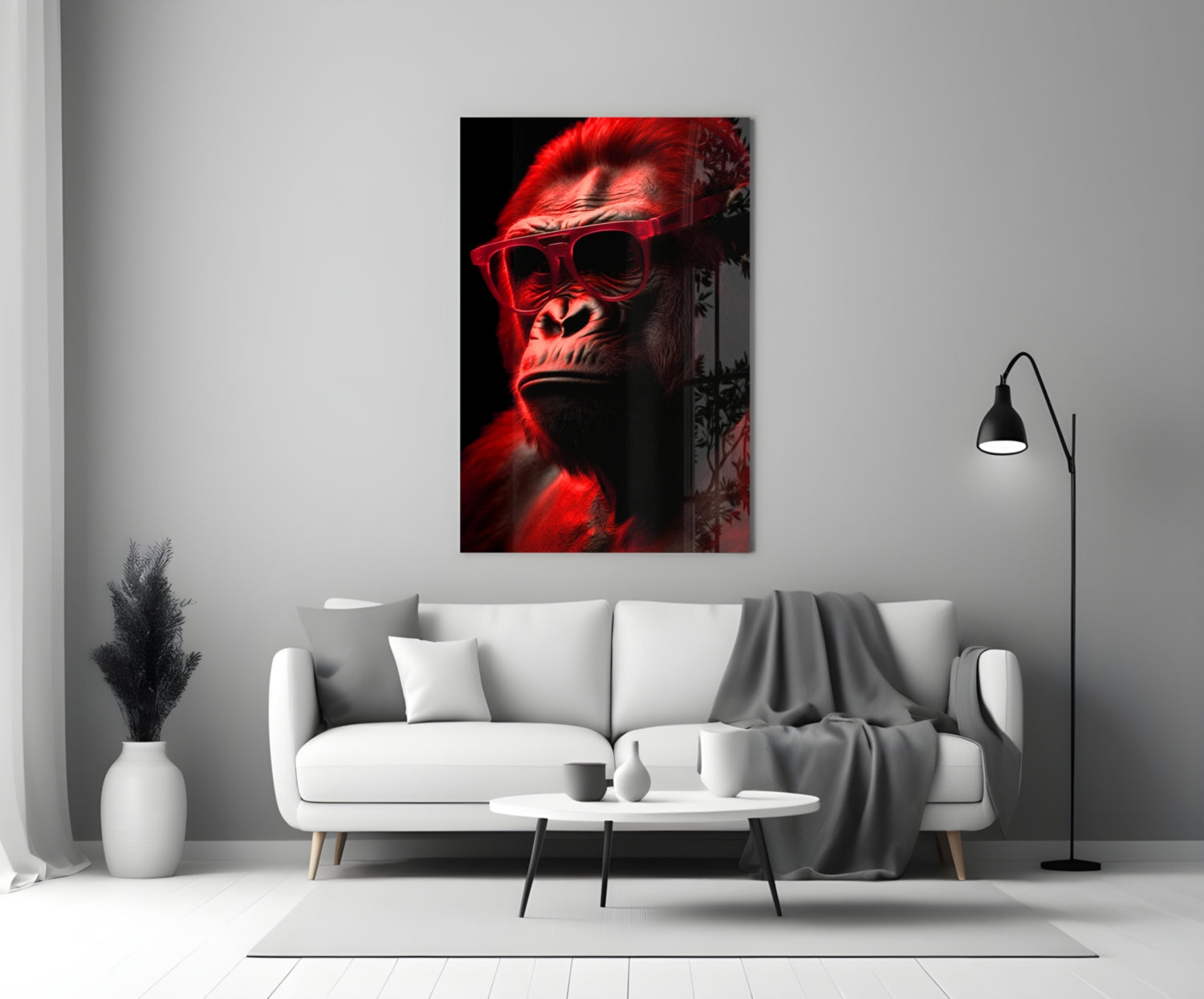 Red-lit gorilla wearing sunglasses displayed on wall above white sofa in minimalist living room setting.