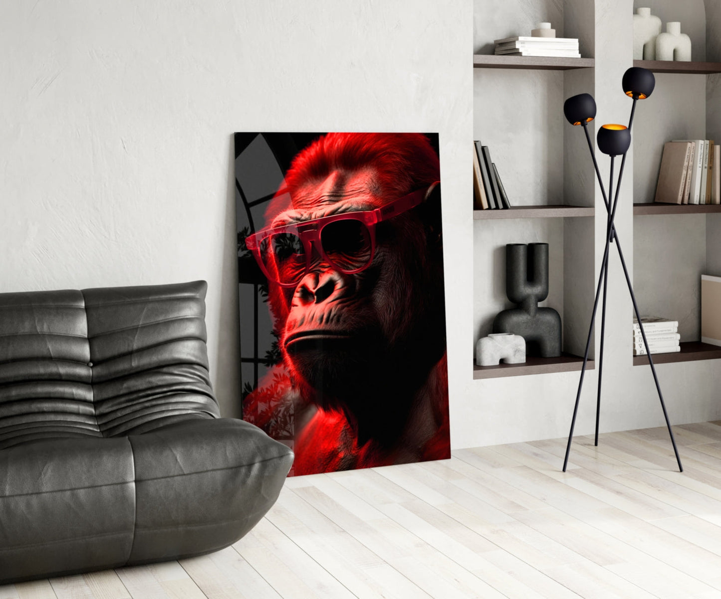 Red-lit primate wearing sunglasses displayed as glass art in modern living room with gray sofa and shelving.