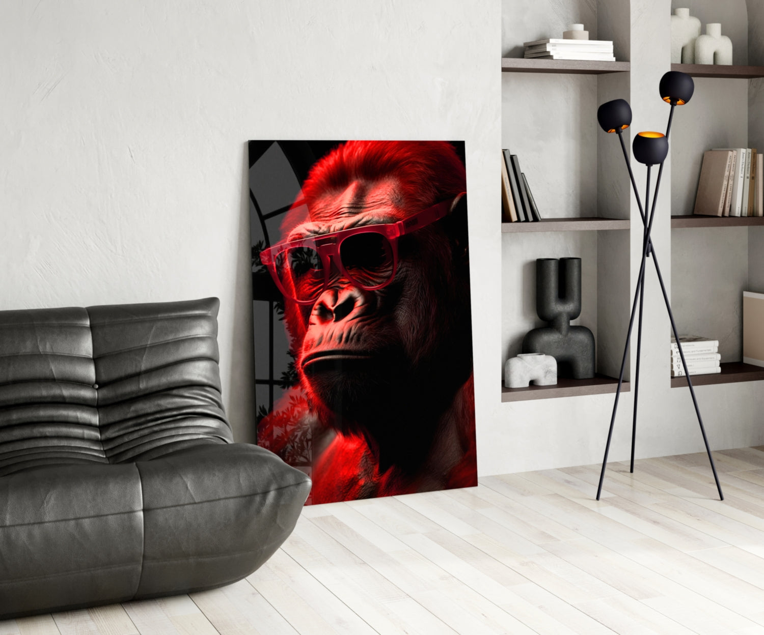 Red-lit primate wearing sunglasses displayed as glass art in modern living room with gray sofa and shelving.
